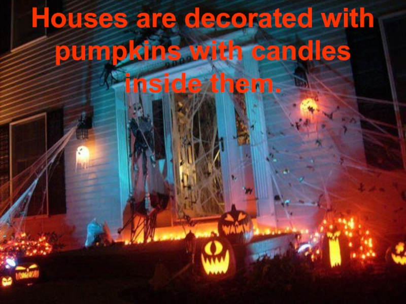 Houses are decorated with pumpkins with candles inside them.